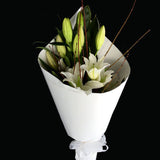 This cut flower bouquet is simply beautiful, a modern composure of stylish white oriental lilies dressed in firm and elegant white paper. Teresa Brough Designer Florist, Takaka NZ